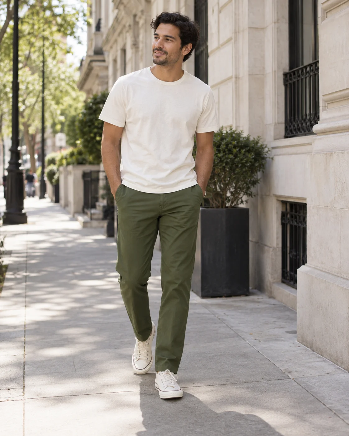 Man wearing olive green chinos with a cream tee and off-white sneakers